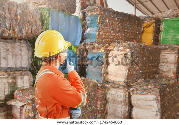 workers in recycling\
factory,engineers standing in recycling center.Garbage recycle in\
the factory at Thai\
Asia.