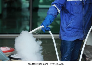 Workers refill liquid nitrogen tanks With gloves, Safety work method.