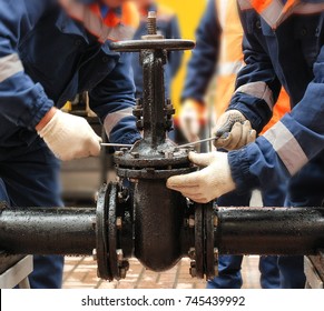 Workers Repair The Pipeline Valve