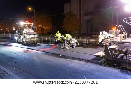 Workers repairing city street at night time