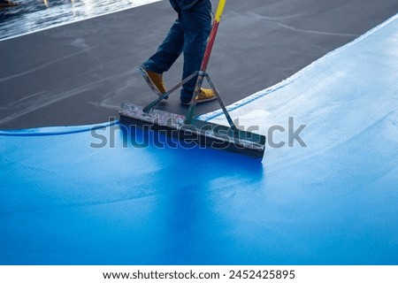 Workers Spreading floor paiting with Squeegee , Tennis court and sport floor painting by squeegee