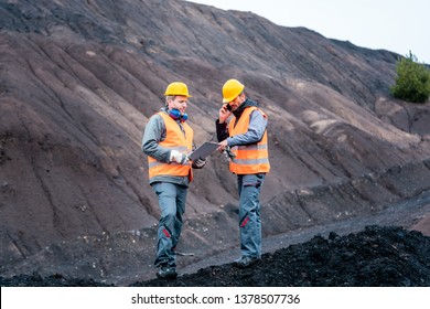 Workers Standing In Open-cast Mining Operation Pit