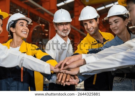 Workers, teamwork and cooperation. Workers join their hands together in industry factory. Unity and teamwork concept