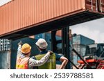 workers teamwork man in safety jumpsuit workwear with yellow hardhat and use laptop check container at cargo shipping warehouse. transportation import,export logistic industrial service