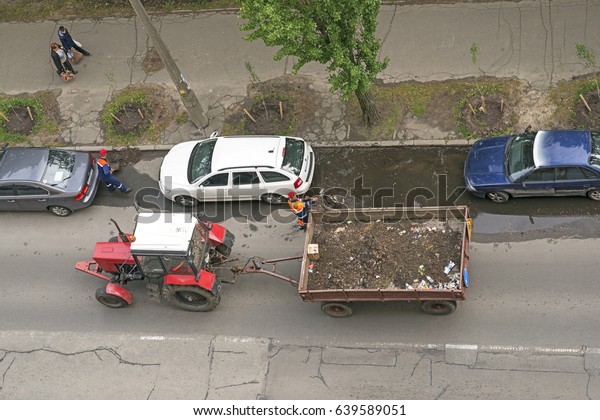 Workers with tractor doing road cleaning, 2017\
May 14, Kyiv (Kiev),\
Ukraine.