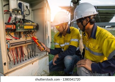 Workers use clamp meter to measure the current of electrical wires produced from solar energy for confirm to normal current. - Shutterstock ID 1380341720
