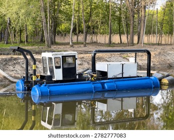 Workers use a machine to clean the river and remove garbage while surrounded by trees and clear water in the daytime.