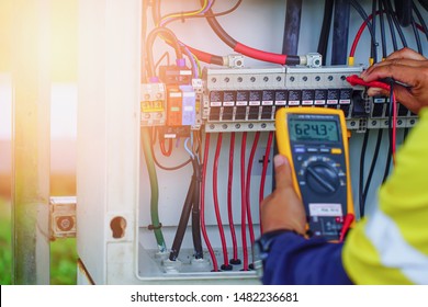 Workers use Multimeter to measure the voltage of electrical wires produced from solar energy for confirm to systems working normal. - Powered by Shutterstock