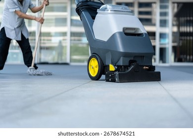 The workers are using a floor scrubber to clean the floor.