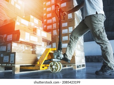 Workers using Hand Pallet Jack Unloading Package Boxes. Commerce Supply Chain. Shipment. Storage Warehouse Cargo Shipping Warehouse Logistics.	