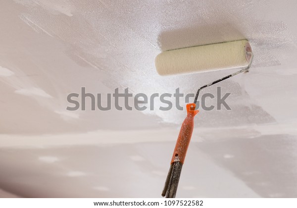 Workers Using Paint Roller On Ceiling Industrial Stock Image