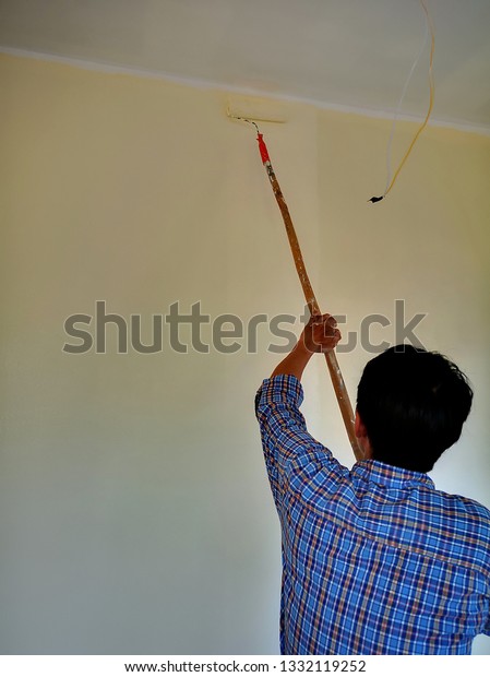 Workers Using Paint Roller On Ceiling People Interiors