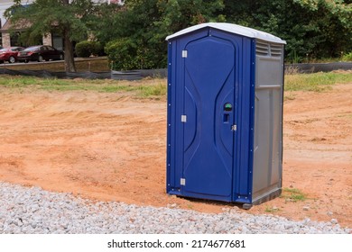 Workers using the portable restroom on a construction site - Shutterstock ID 2174677681