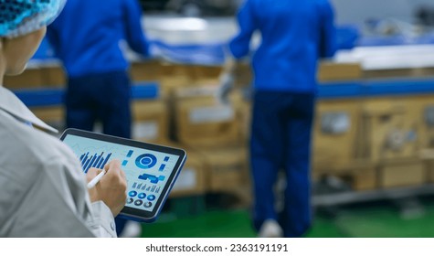 Workers using tablets at a distribution center.