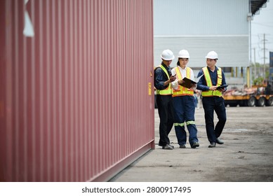 Workers walking and inspecting cargo containers