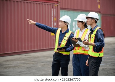Workers walking and inspecting cargo containers