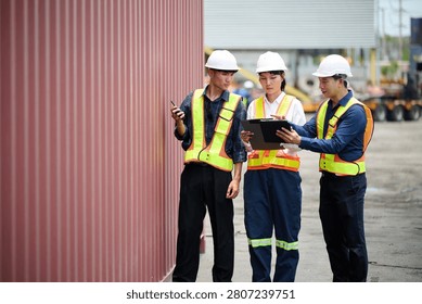 Workers walking and inspecting cargo containers