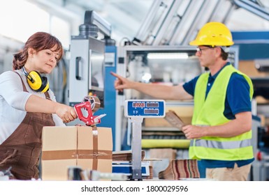 Workers in warehouse, packaging process