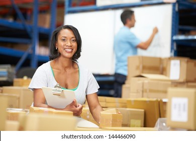 Workers In Warehouse Preparing Goods For Dispatch - Powered by Shutterstock