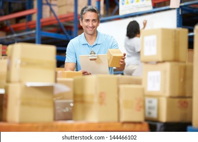 Workers In Warehouse Preparing Goods For Dispatch - Powered by Shutterstock