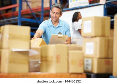 Workers In Warehouse Preparing Goods For Dispatch - Powered by Shutterstock