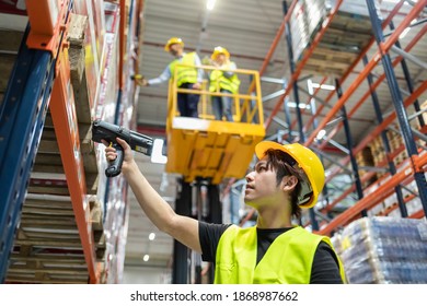Workers in warehouse scanning packages