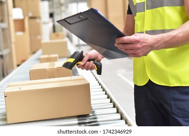 workers in the warehouse scanning parcels for retail and transport shipping 