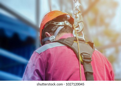 Workers Wear Red Dress Closeup With Safety Harness, Safety Equipment And Safety Belts 