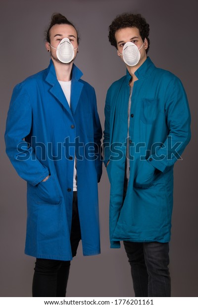 workers wearing mask and blue protective work wear\
coat, isolated studio shot\
