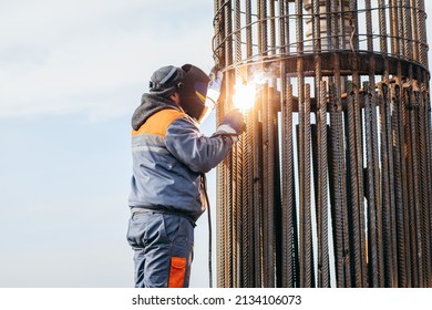 Workers is welding metal parts of concrete bridge - Powered by Shutterstock