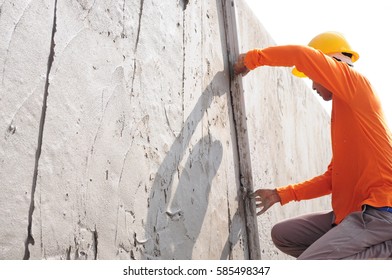 Workers were plastering the walls, roof deck. - Shutterstock ID 585498347