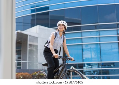 Workers Woman Go Cycling In The City To Work 