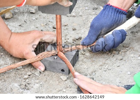 Workers are working connect  ground wire protection system.
