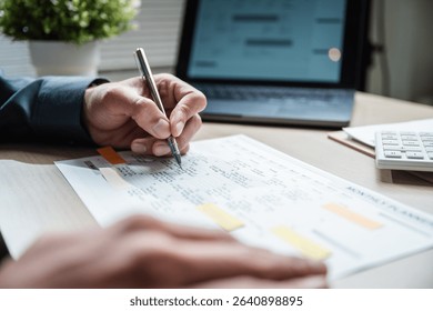 Workflow process solution plan management. Flowchart implement strategy interface diagram. A man is writing on a piece of paper with a pen. Concept of focus and concentration as the man writes.