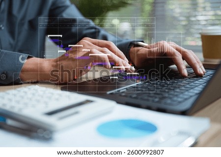Workflow process solution plan management. Flowchart implement strategy interface diagram. A man is typing on a laptop with a calendar on the screen. He is using a calculator and a pen on the desk.