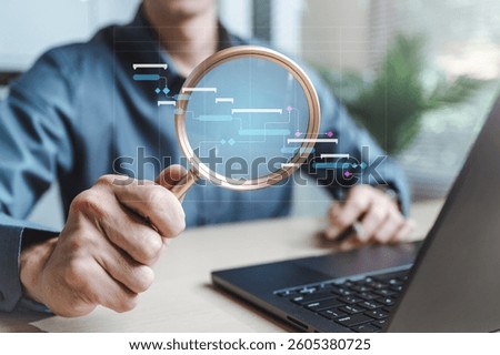 Workflow process solution plan management. Flowchart implement strategy interface diagram. A man is holding a magnifying glass over a laptop computer. Concept of curiosity and investigation.