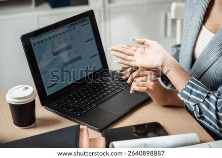 Workflow process solution plan management. Flowchart implement strategy interface diagram. Two women are working on a laptop together. One of them is holding her hand up to the screen.