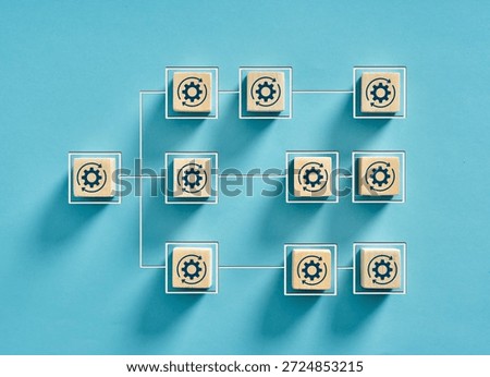 Workflow process visualized with wooden cubes arranged hierarchically and connected by lines, symbolizing interconnected steps and efficient task management