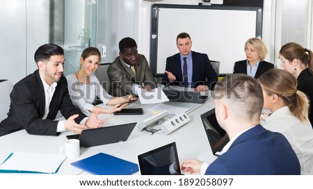 workgroup of business discuss ideas for teamwork in the office
