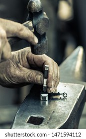 Working With The Anvil. Texture. Hands.