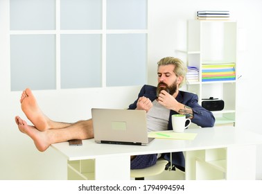 Working Barefoot At Home Office. Social Distancing Concept. Man Is Working At Home During Coronavirus Pandemic. Relaxed Man Sit On Comfortable Chair Using Laptop. Online In Social Media. Billionaire.