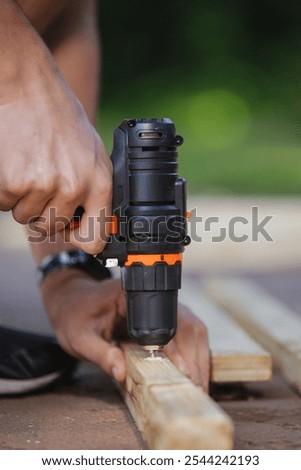 Working with a black screwdriver on a construction site