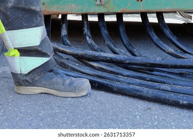 Working boot. Electricity cable work. Low angle.