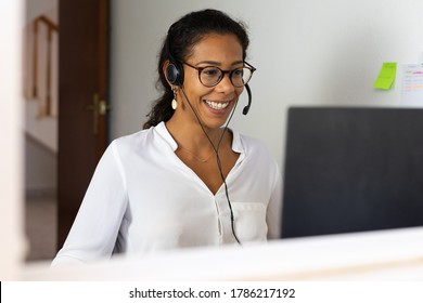 Working brazilian young woman in bedroom. Telemeeting. Video conference. Remote work. Call center home.