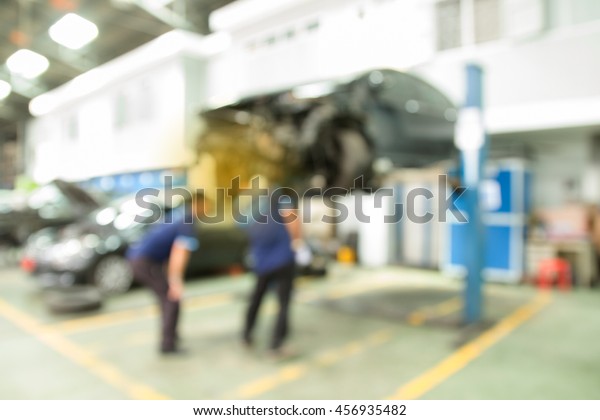 working car mechanic inspection  of accident in garage.\
Blur image style 