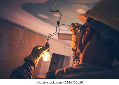 Working Contractor Electrician. Fixing the Light.