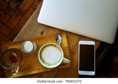 Working corner with Top view cup of green tea