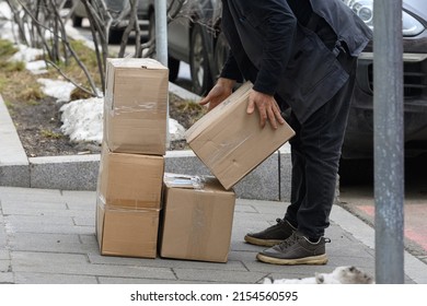 A Working Courier Lifting Shipping Boxes, Packaging, Cardboard Box, Warehouse Delivery Service.