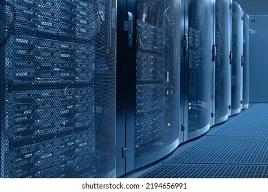 Working data center. Centers data center with multiple rows. Data center in server room with server racks. Concept cloud computing, artificial intelligence, supercomputer, cybersecurity