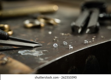 Working desk for craft jewelery making with professional tools. Still life of goldsmith's tools with diamonds. Macro shot.